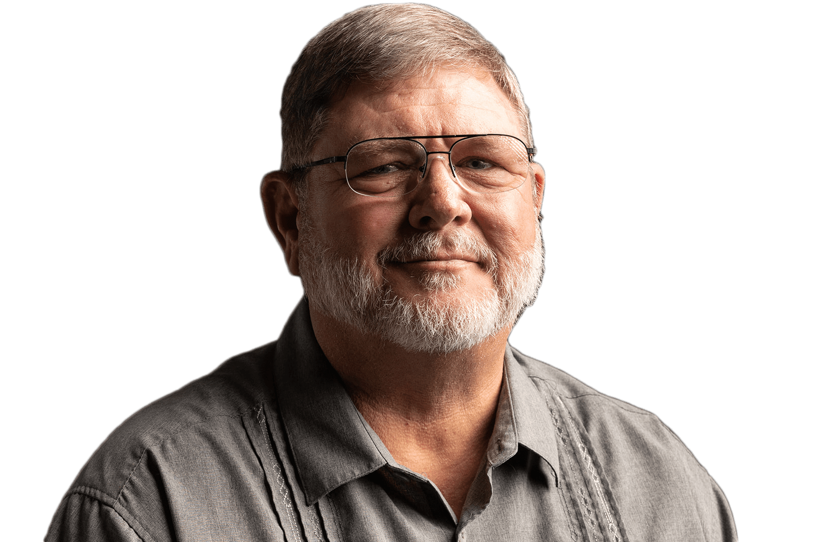 A man with glasses and beard wearing a gray shirt.