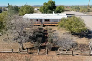 A house with trees and a fence in the background