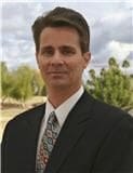 A man in a suit and tie standing outside.