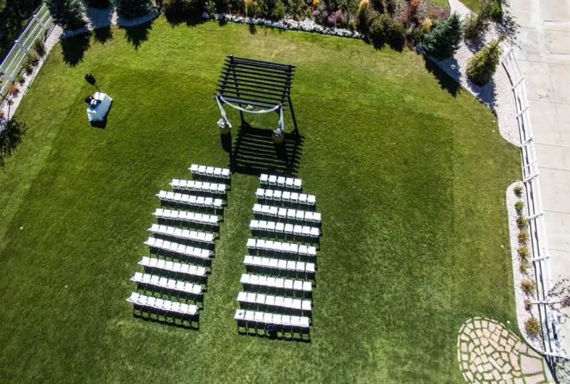 An aerial view of a lawn with chairs and benches.